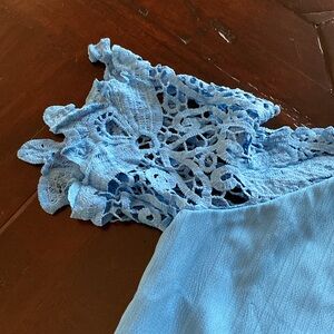 Pretty summer cold shoulder blouse. Sized large but fits small.